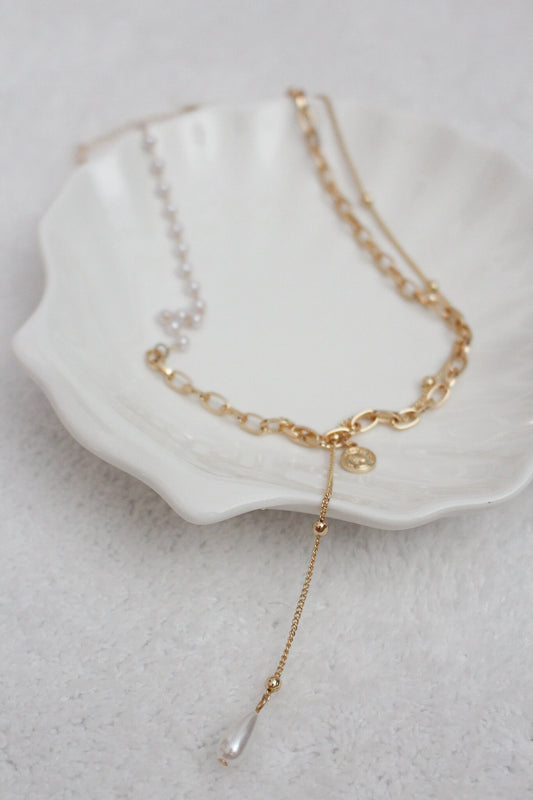A gold necklace with pearl embellishments