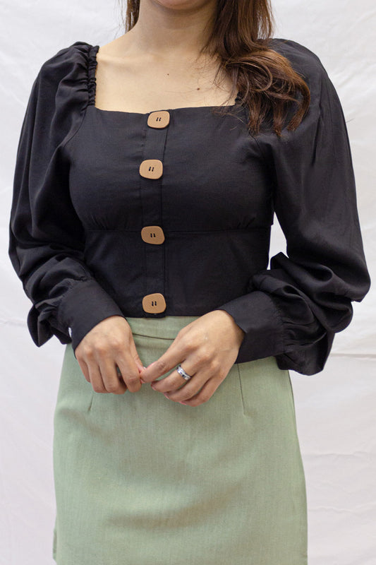 A square neck cropped top with long puffed sleeves. Complete with wooden finish buttons. 