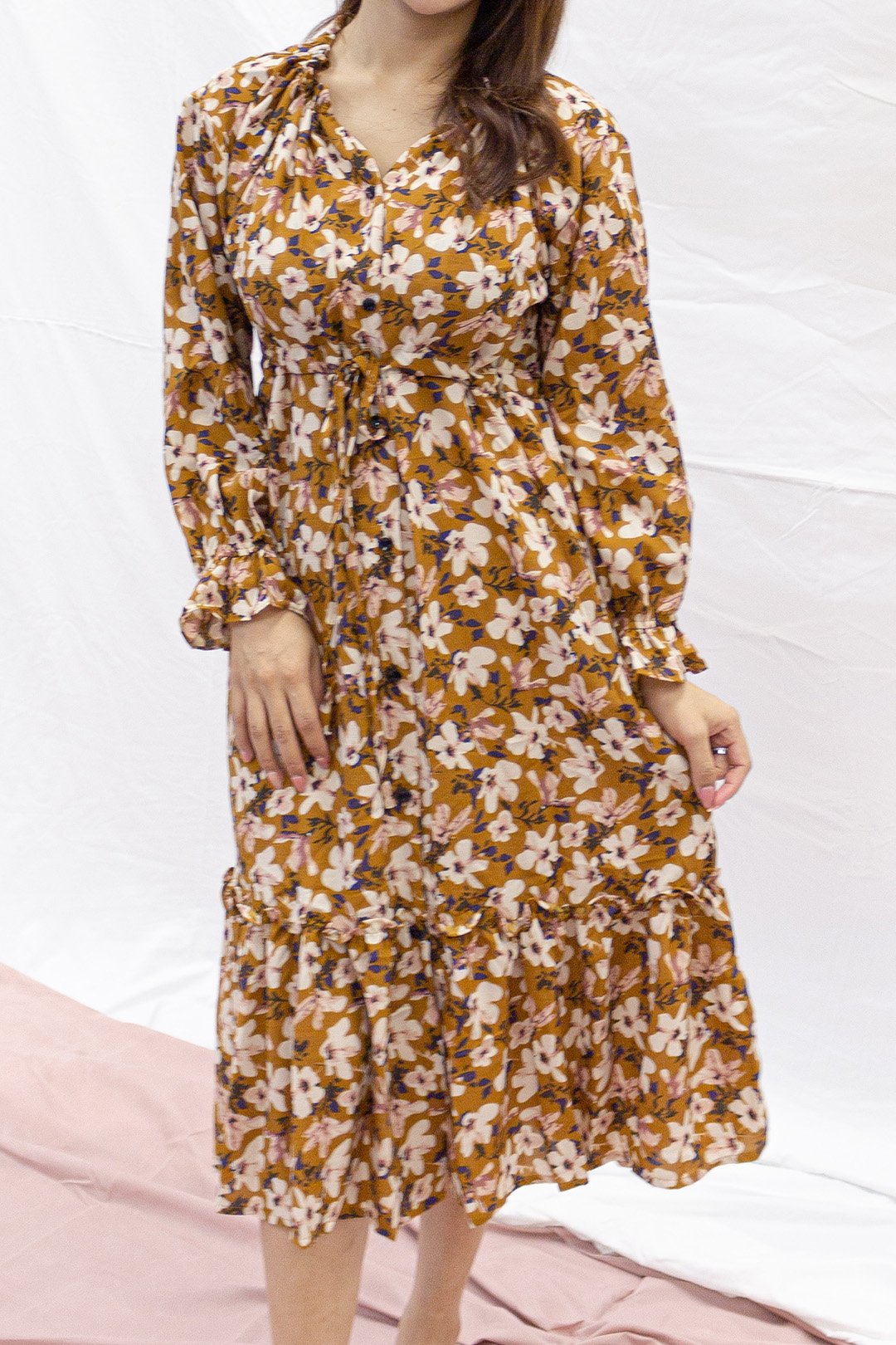 Long sleeve maxi dress with ruffle bottom, features a waist tie to bring in waist shape.