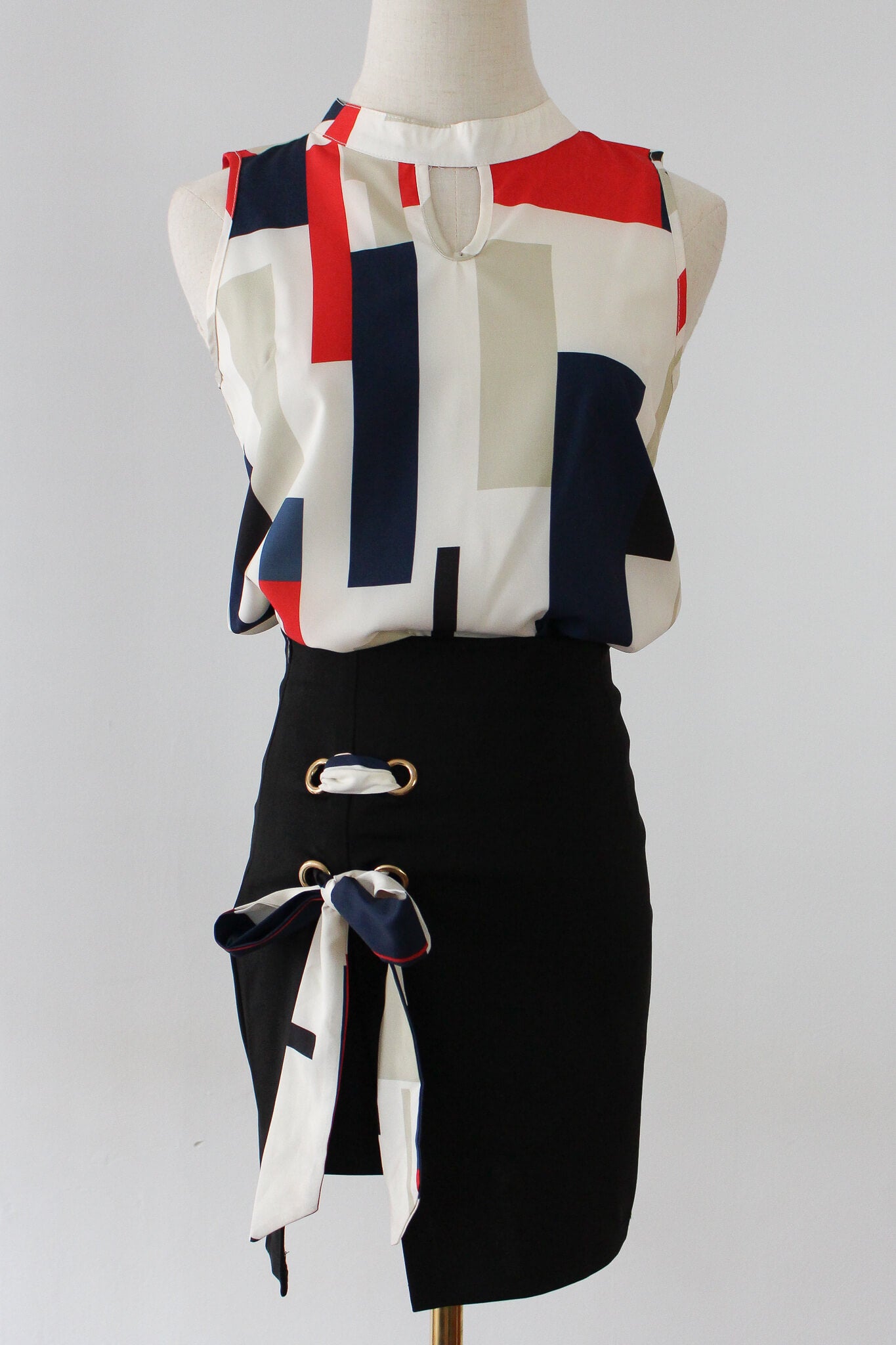 Colorblock blouse with ribboned skirt, perfect for work.