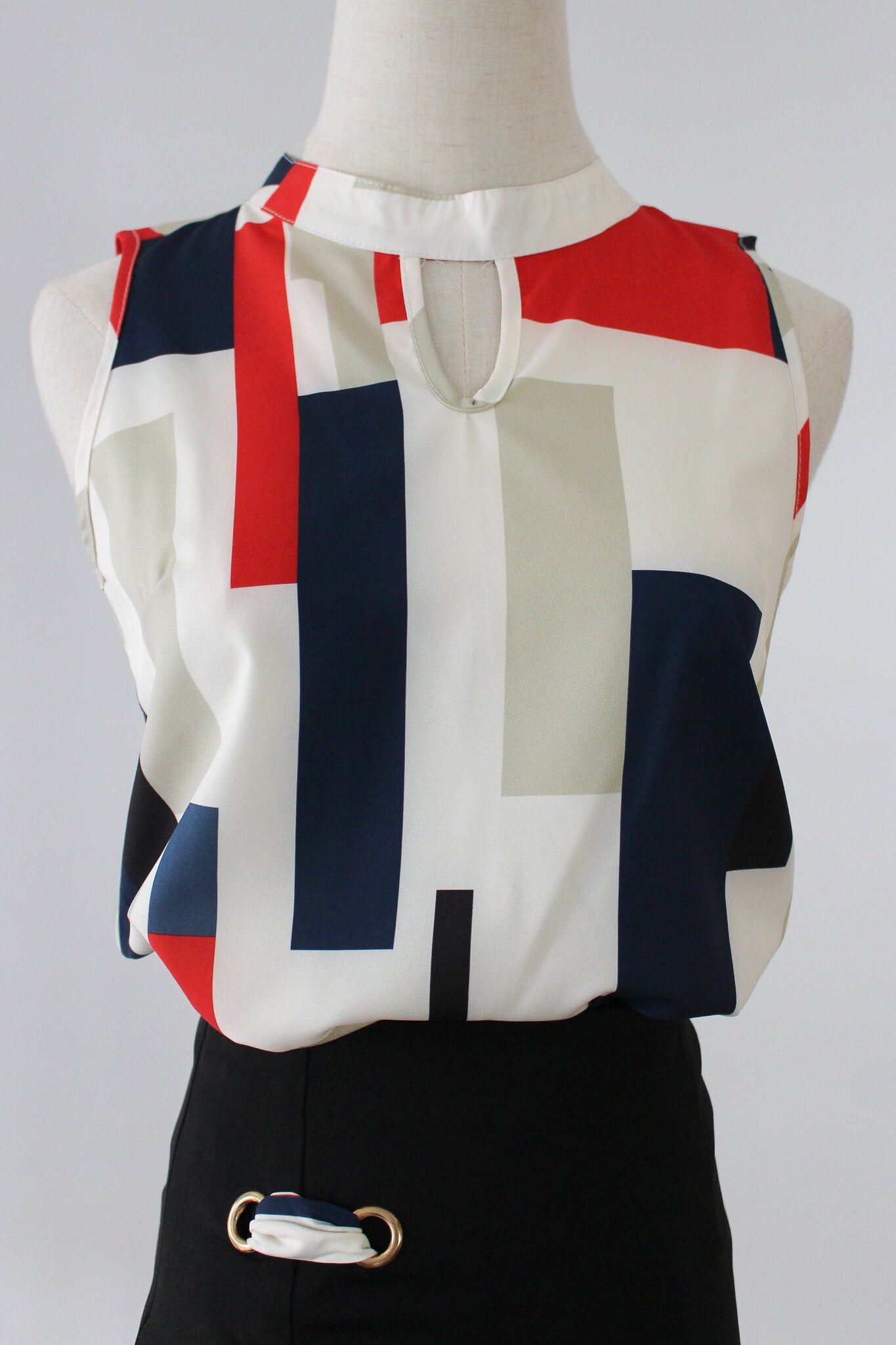 Colorblock blouse with ribboned skirt, perfect for work.